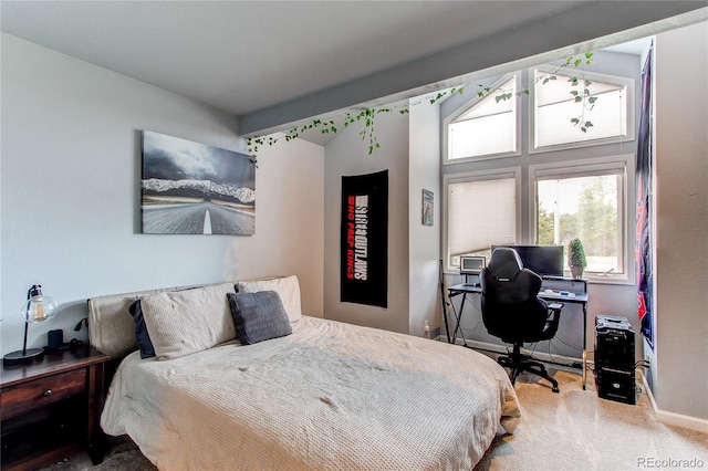 carpeted bedroom featuring lofted ceiling