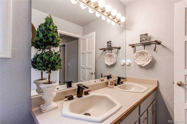 bathroom with a sink and double vanity