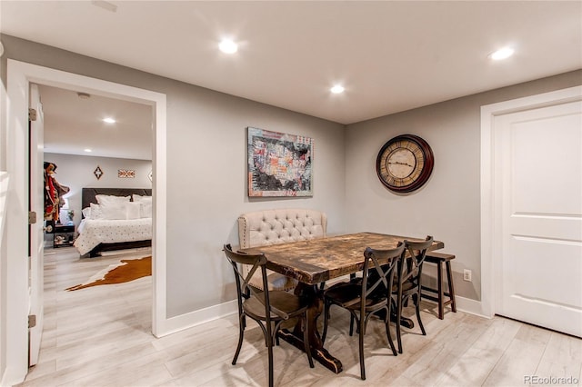 dining area featuring baseboards, light wood-type flooring, and recessed lighting