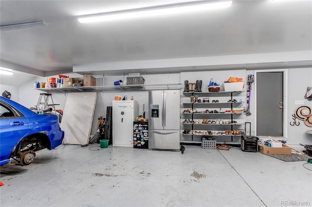 garage with stainless steel refrigerator with ice dispenser