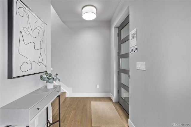 interior space featuring baseboards and wood finished floors