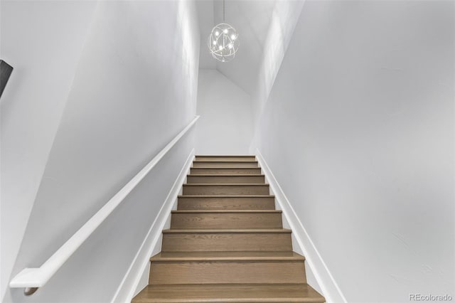 staircase featuring a chandelier