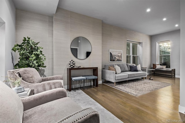 living room with recessed lighting, baseboards, and wood finished floors