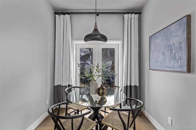 dining room with baseboards and wood finished floors