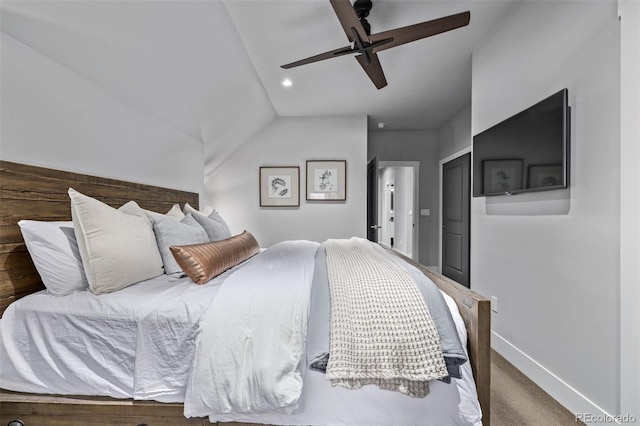 carpeted bedroom with vaulted ceiling, a ceiling fan, and baseboards