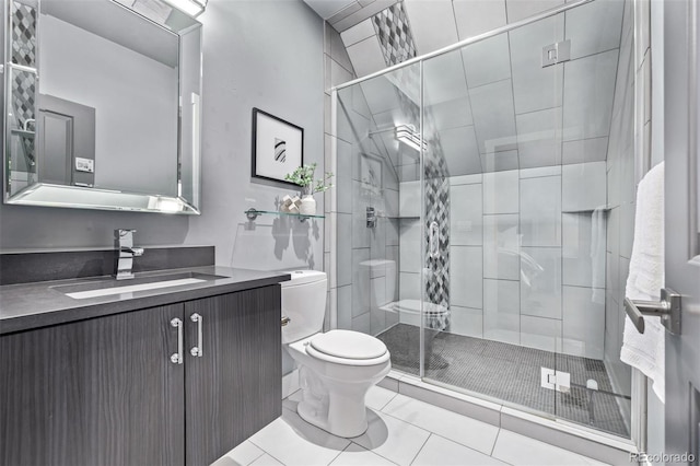 full bathroom featuring toilet, a shower stall, tile patterned flooring, and vanity