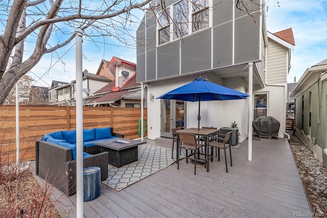 deck with fence, outdoor dining area, area for grilling, and an outdoor living space with a fire pit