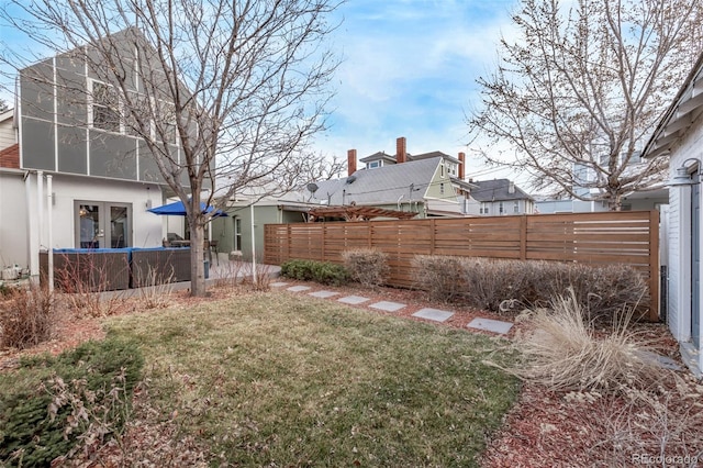 view of yard featuring fence, a patio, and french doors