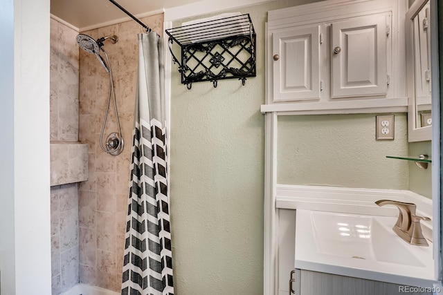 bathroom featuring sink and a shower with shower curtain