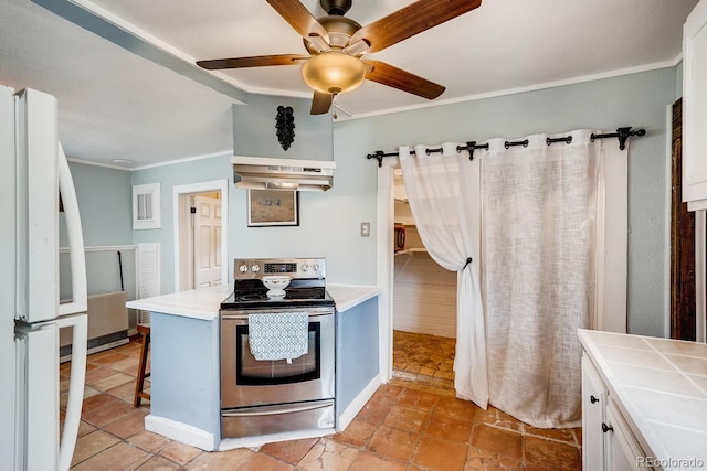 kitchen with white cabinets, white refrigerator, electric range, ceiling fan, and tile counters