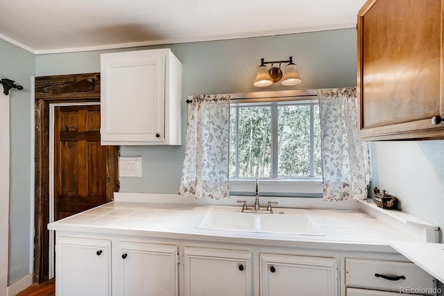 kitchen with white cabinetry and sink