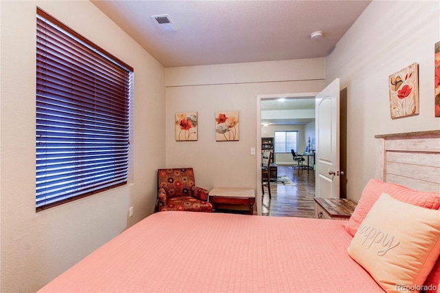 bedroom with visible vents and wood finished floors