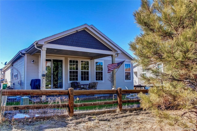 rear view of property with fence