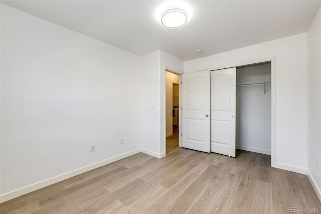 unfurnished bedroom featuring a closet and light hardwood / wood-style flooring