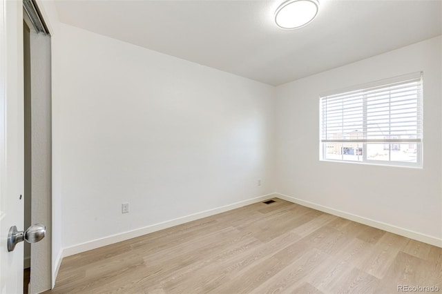 spare room with light hardwood / wood-style floors