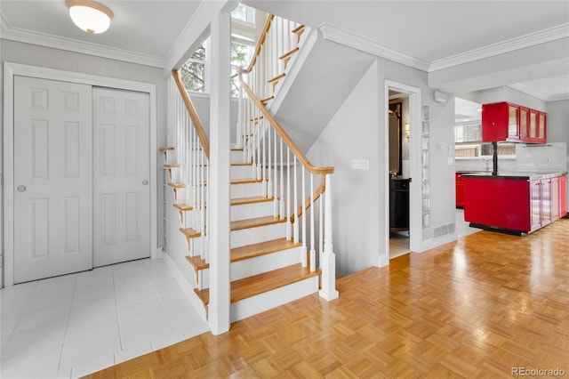 stairs featuring crown molding and baseboards