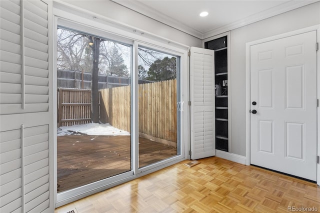 doorway with recessed lighting, baseboards, a healthy amount of sunlight, and crown molding