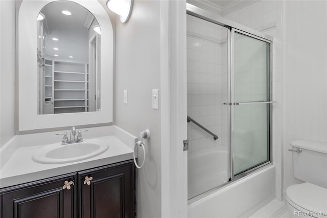 full bathroom featuring bath / shower combo with glass door, toilet, ornamental molding, recessed lighting, and vanity