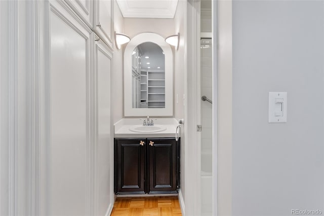 bathroom with vanity and ornamental molding