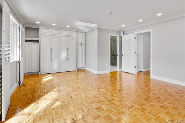 interior space featuring recessed lighting, baseboards, and crown molding