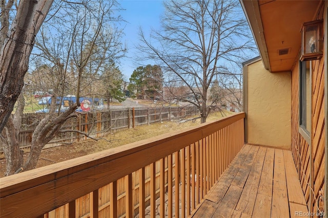 wooden terrace featuring fence