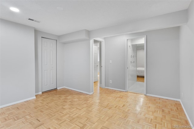 unfurnished bedroom with visible vents, baseboards, a textured ceiling, and a closet