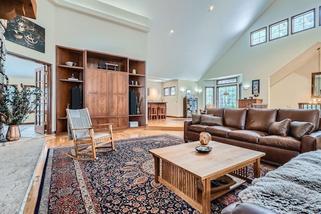 living area featuring light wood-style flooring and high vaulted ceiling