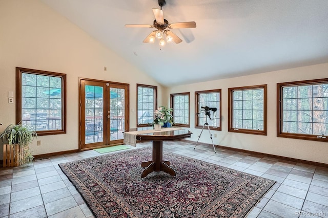 foyer entrance with a wealth of natural light, light tile patterned floors, french doors, and ceiling fan