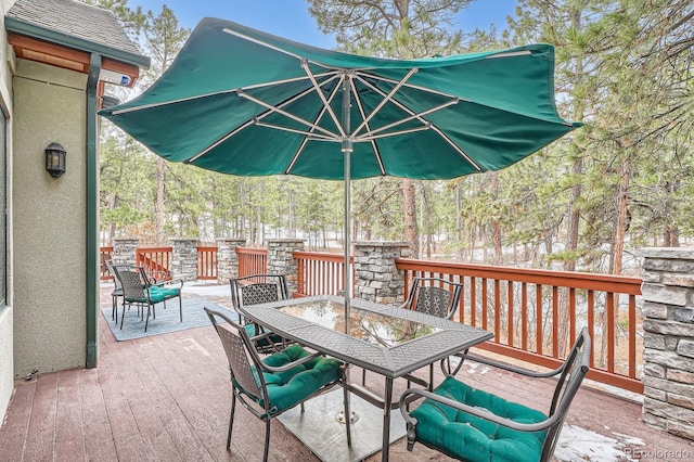 view of patio featuring outdoor dining space and a wooden deck