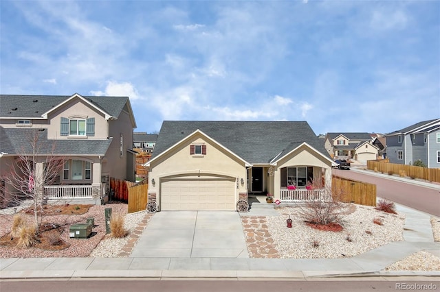 2734 Grand Prix Ct, Colorado Springs, CO 80922 - view of front of home featuring a porch, stucco siding, driveway, fence, and an attached garage