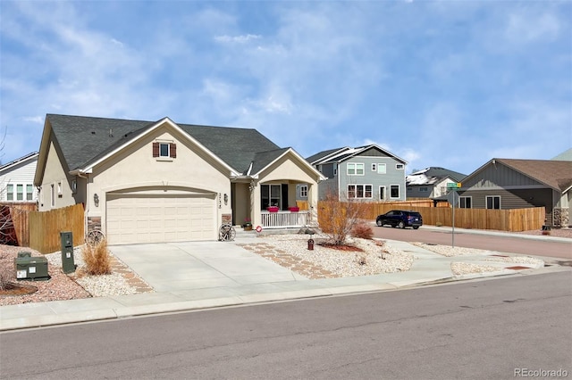 2734 Grand Prix Ct, Colorado Springs, CO 80922 - view of front of property with stucco siding, fence, driveway, an attached garage, and a residential view