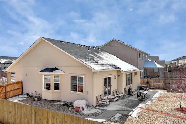 2734 Grand Prix Ct, Colorado Springs, CO 80922 - rear view of property featuring stucco siding, a fenced backyard, a patio area, and a shingled roof