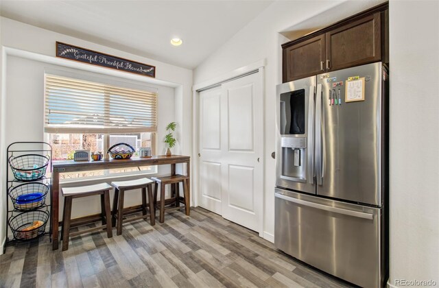 2734 Grand Prix Ct, Colorado Springs, CO 80922 - kitchen with stainless steel refrigerator with ice dispenser, dark brown cabinets, light wood finished floors, and recessed lighting