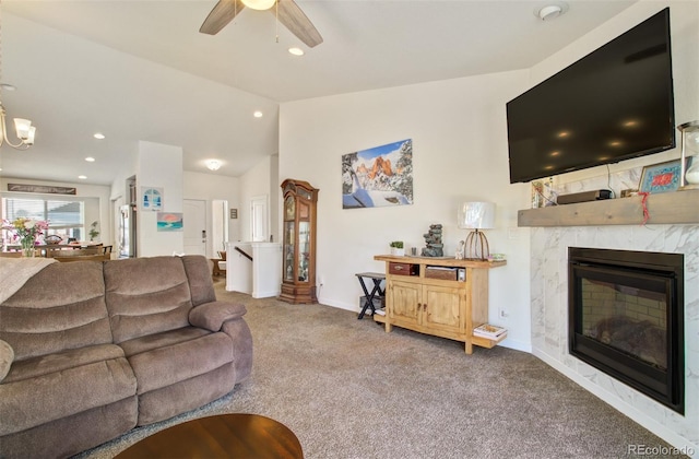 2734 Grand Prix Ct, Colorado Springs, CO 80922 - carpeted living area with lofted ceiling, ceiling fan, a high end fireplace, baseboards, and recessed lighting