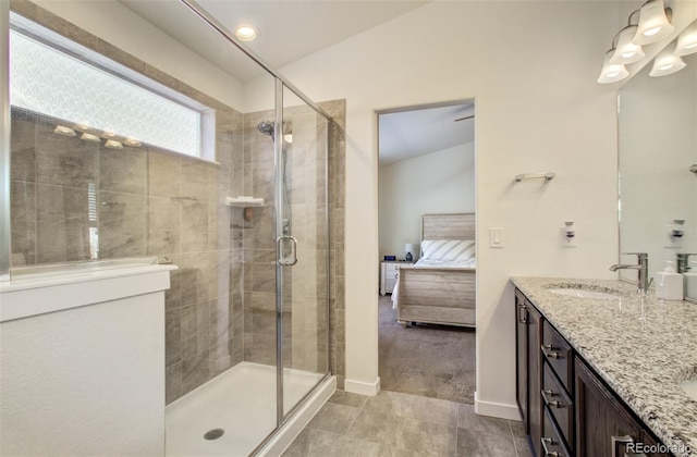 2734 Grand Prix Ct, Colorado Springs, CO 80922 - ensuite bathroom featuring a shower stall, double vanity, baseboards, and tile patterned floors