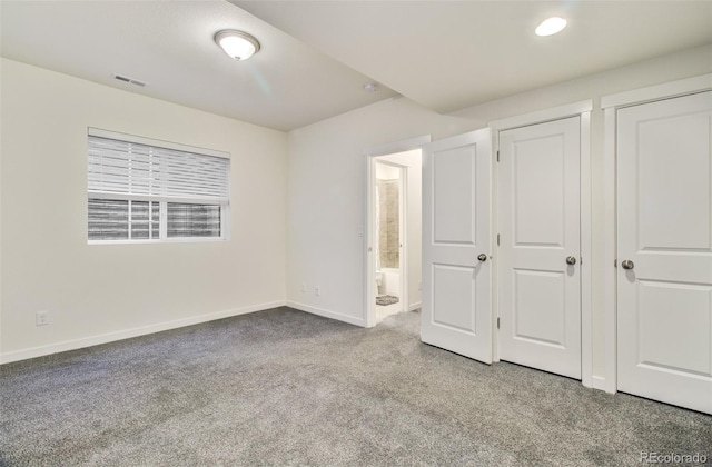 2734 Grand Prix Ct, Colorado Springs, CO 80922 - unfurnished bedroom featuring carpet, baseboards, ensuite bathroom, and two closets