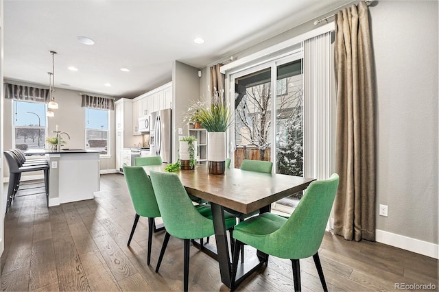 dining room featuring dark wood-style floors, baseboards, and recessed lighting