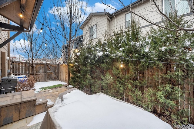 snow covered property with fence