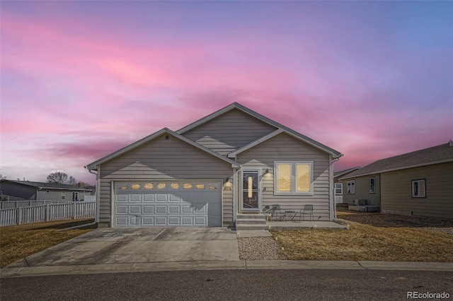 view of front facade featuring a garage, concrete driveway, and fence