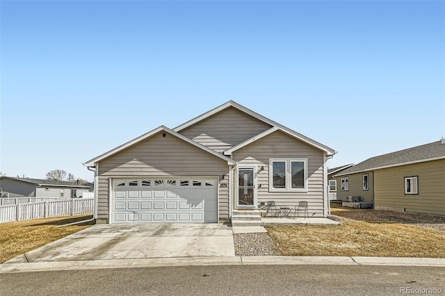 ranch-style house featuring driveway, a garage, and fence