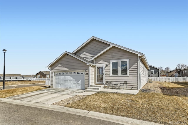 single story home featuring concrete driveway, an attached garage, and fence