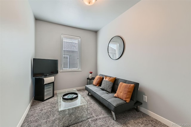 carpeted living area with baseboards