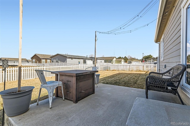 view of patio / terrace featuring a fenced backyard and a residential view