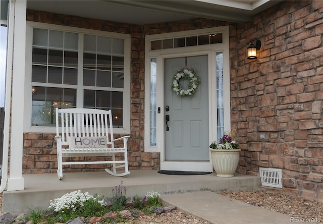 9684 W Long Dr, Littleton, CO 80123 - property entrance featuring covered porch and stone siding
