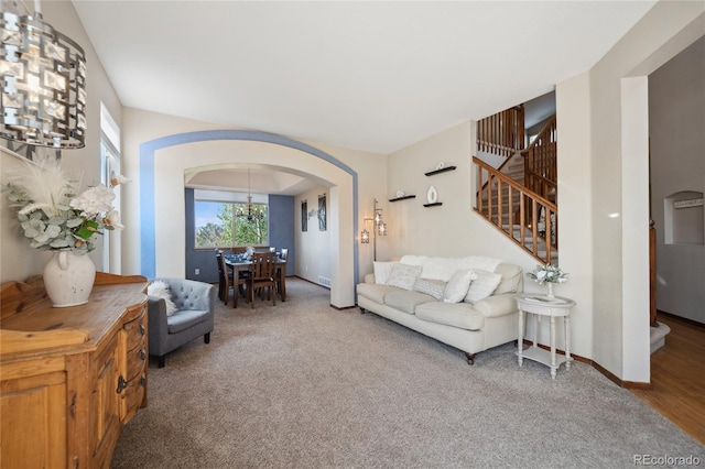 9684 W Long Dr, Littleton, CO 80123 - living area with arched walkways, stairs, carpet, a chandelier, and baseboards