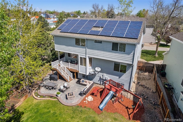 9684 W Long Dr, Littleton, CO 80123 - back of house with solar panels, a patio area, roof with shingles, a playground, and a deck