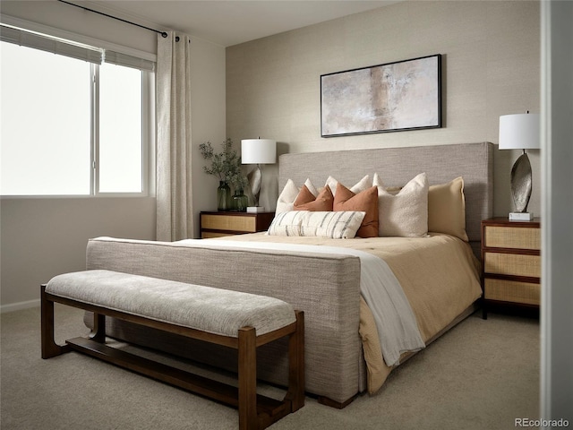 bedroom with baseboards and light colored carpet