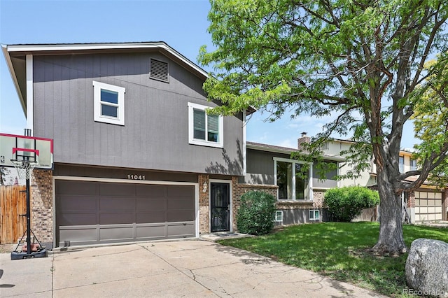 11041 Newland St, Westminster, CO 80020 - split level home featuring brick siding, a garage, concrete driveway, and a chimney