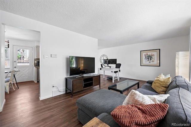 11041 Newland St, Westminster, CO 80020 - living room with dark wood-style floors, a textured ceiling, and baseboards