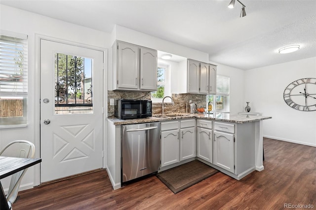 11041 Newland St, Westminster, CO 80020 - kitchen featuring stainless steel dishwasher, a sink, a peninsula, black microwave, and dark wood-type flooring